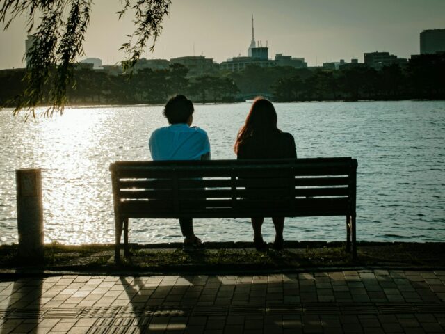 Couple sitting on park bench