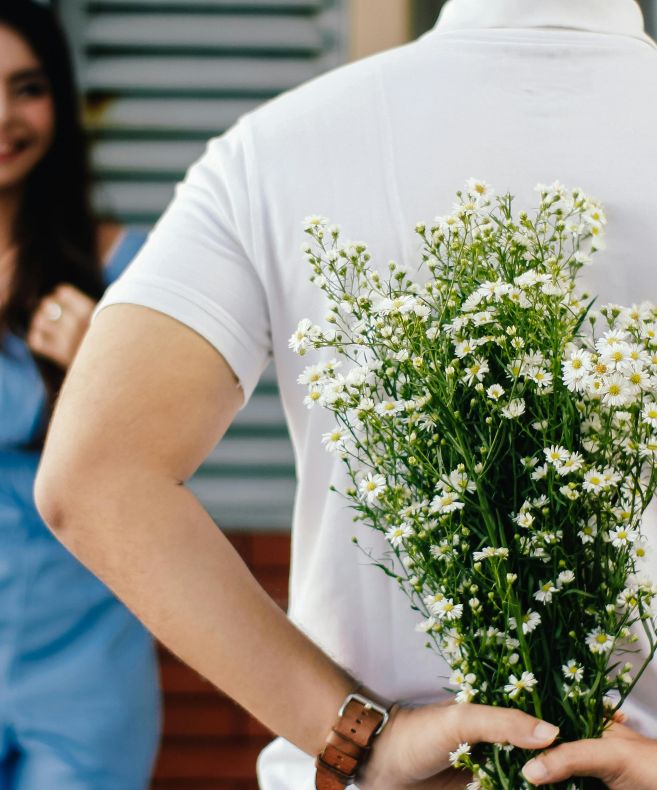 Man Holding Baby's-breath Flower in Front of Woman